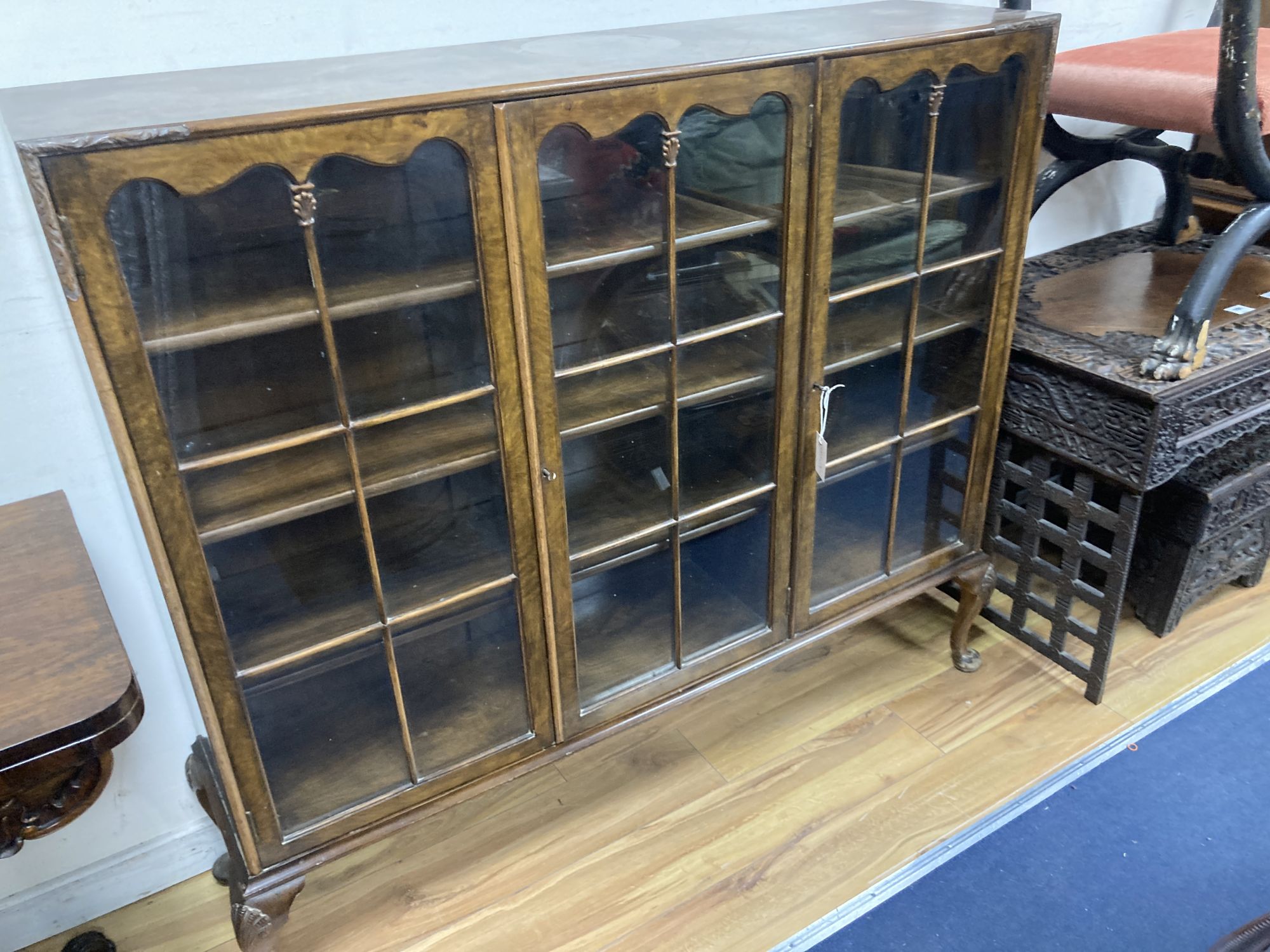 A Queen Anne revival burr walnut three door glazed bookcase, width 132cm, depth 33cm, height 118cm